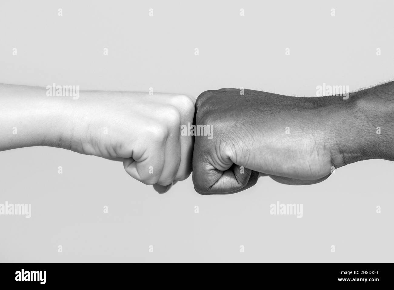 Black African American race male and woman hands giving a fist bump, multiracial diversity, immigration concept. Stop racism campaign. Closeup of Stock Photo