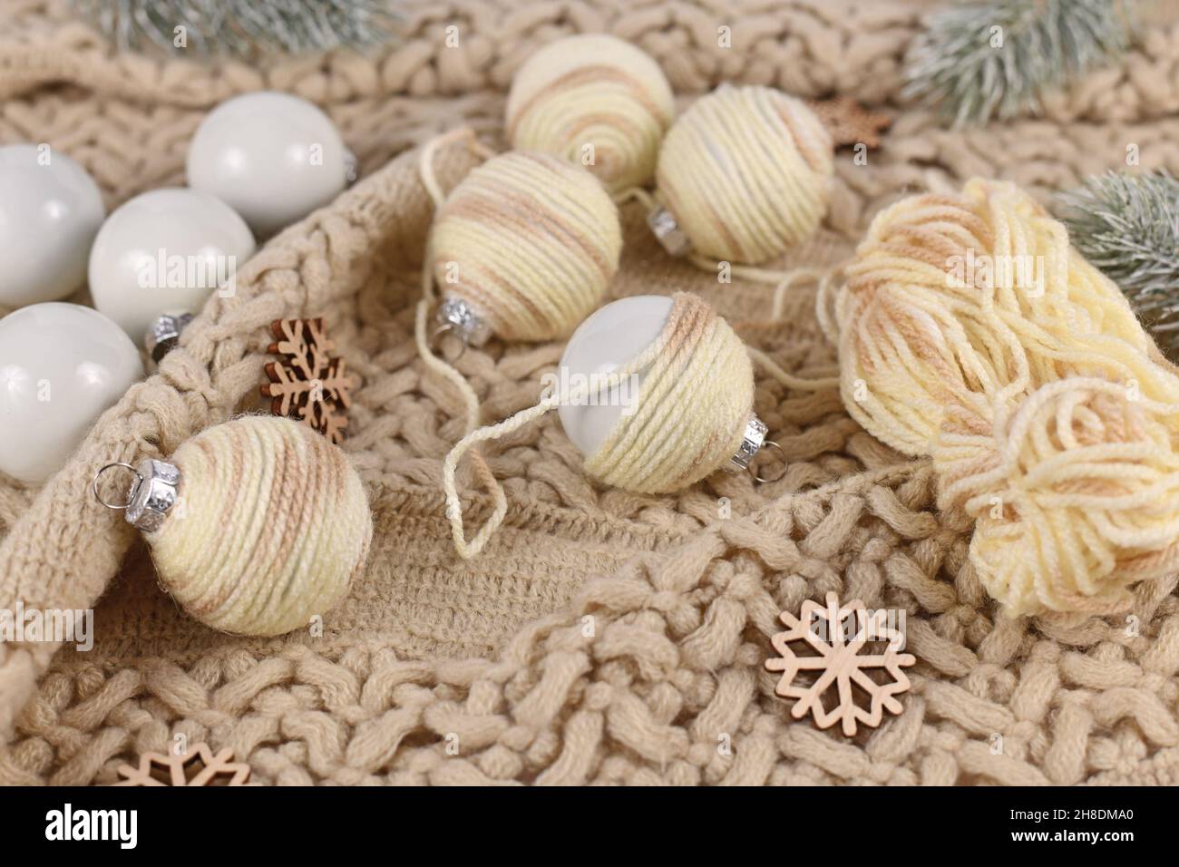 Boho style DIY Christmas bauble ornaments with with cream colored wool cord Stock Photo