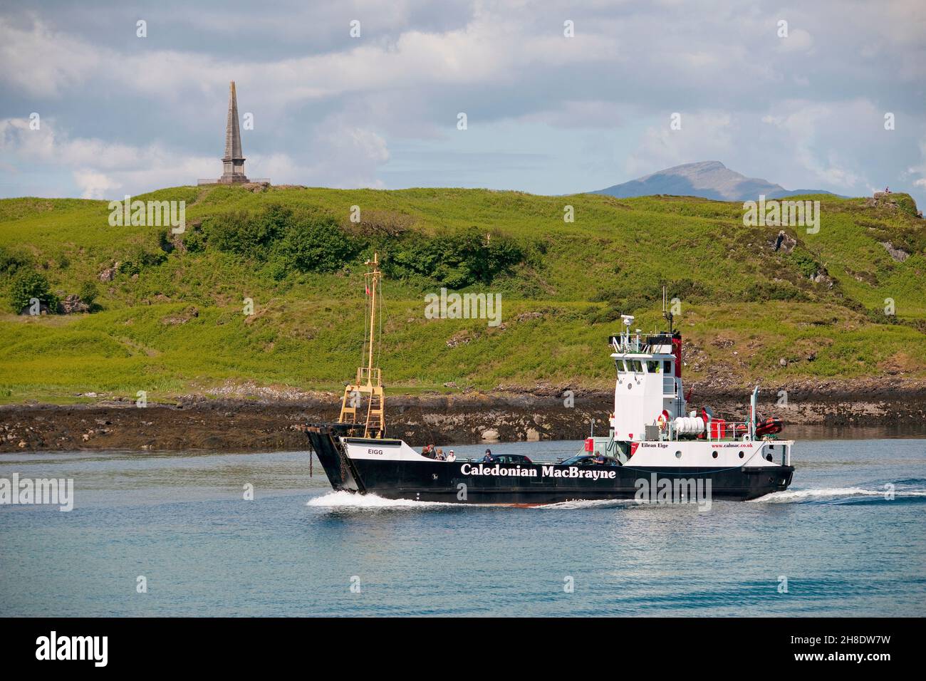 The Mv Eigg passing the Hutchesons monument on Kerrera in 2012. Oban, Argyll Stock Photo