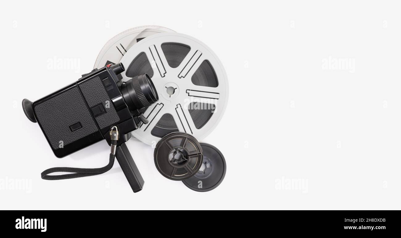 Vintage super 8 camera and film reels on white background. Movie film background. Copy space Stock Photo