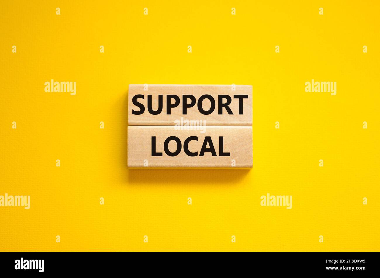 Time to support local symbol. Wooden blocks with words 'Support local'. Beautiful yellow background. Business and time to support local concept. Copy Stock Photo