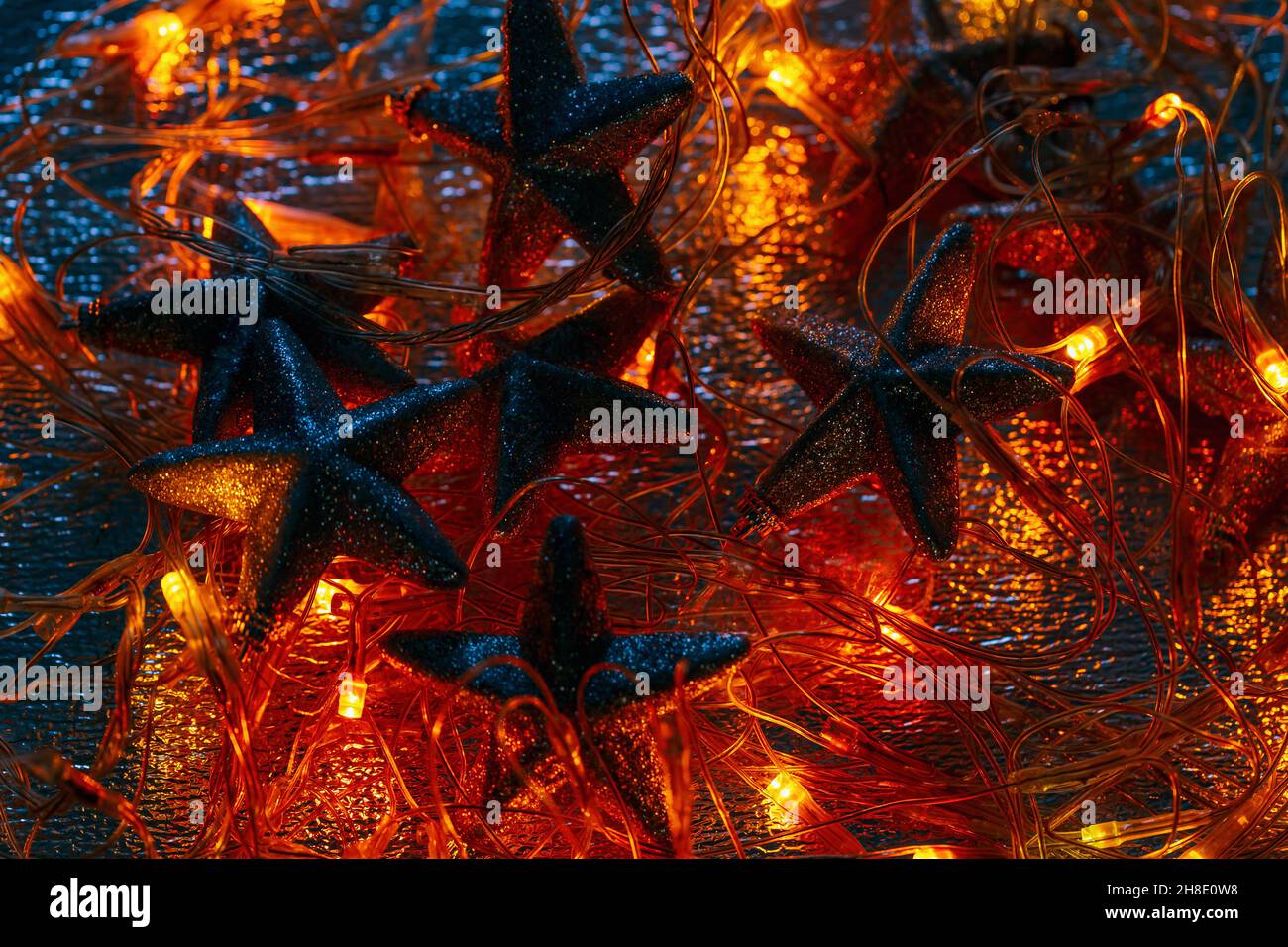 Abstract dark magic Christmas background with garland and stars Stock Photo