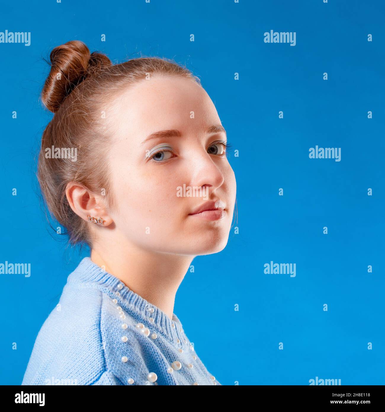 Portrait of a cute girl on blue background Stock Photo