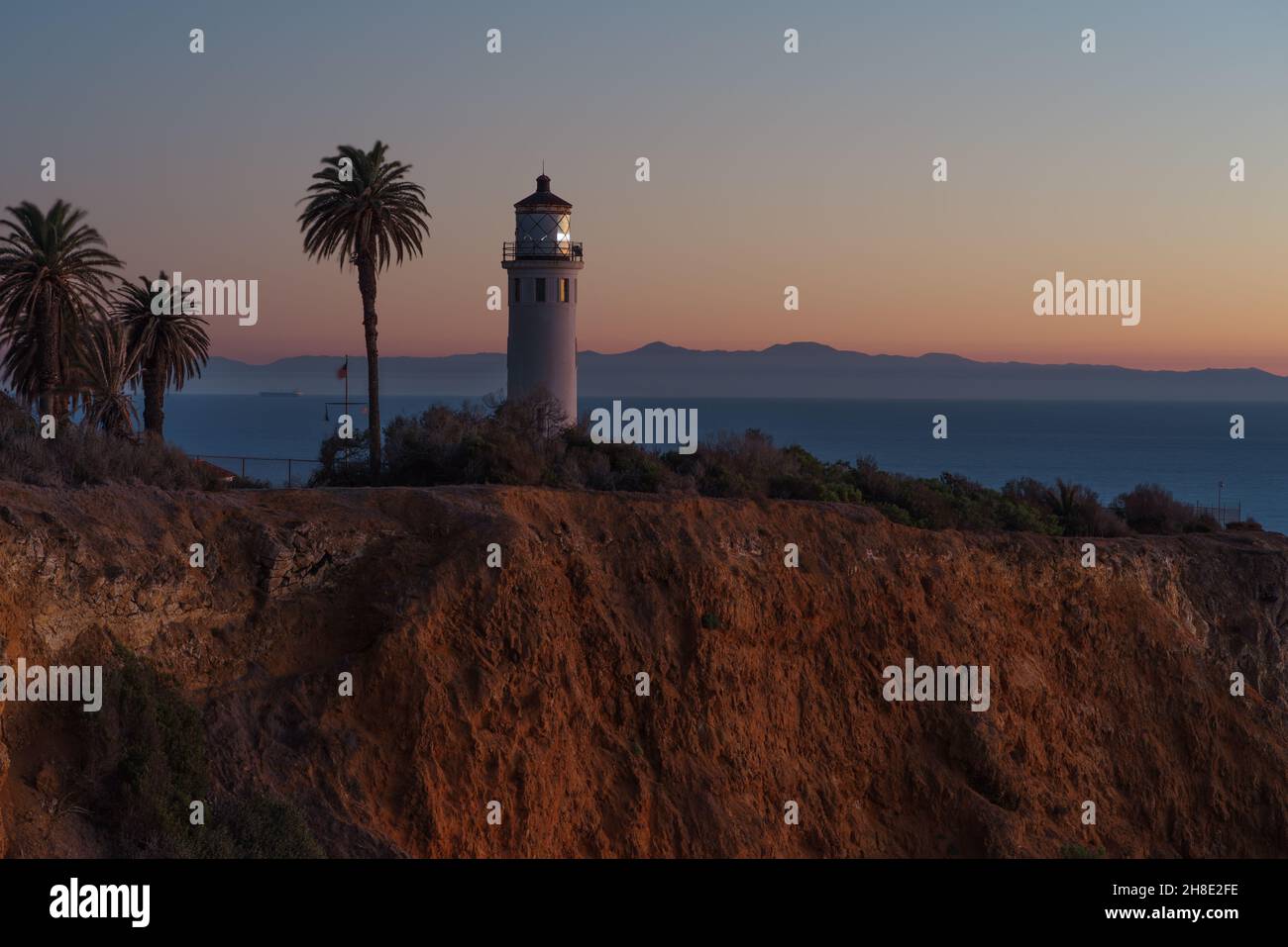 Point Vicente Lighthouse in Rancho Palos Verdes at dusk. The Santa Catalina Island is shown in the background. Stock Photo