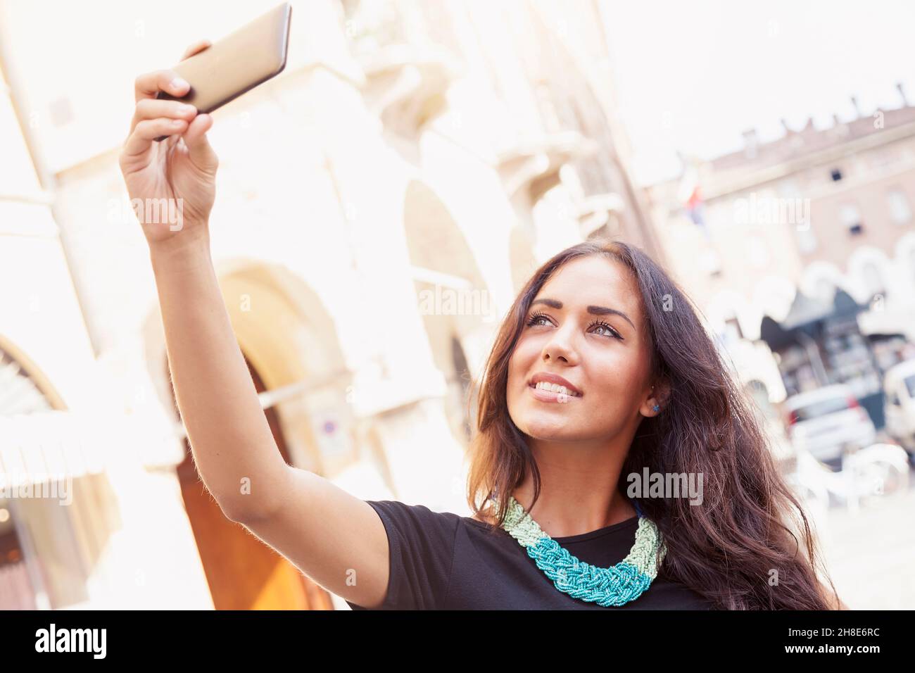 pretty young girl tourist takes a selfie in the old town Stock Photo