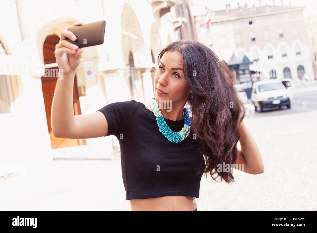 pretty young girl tourist takes a selfie in the old town Stock Photo
