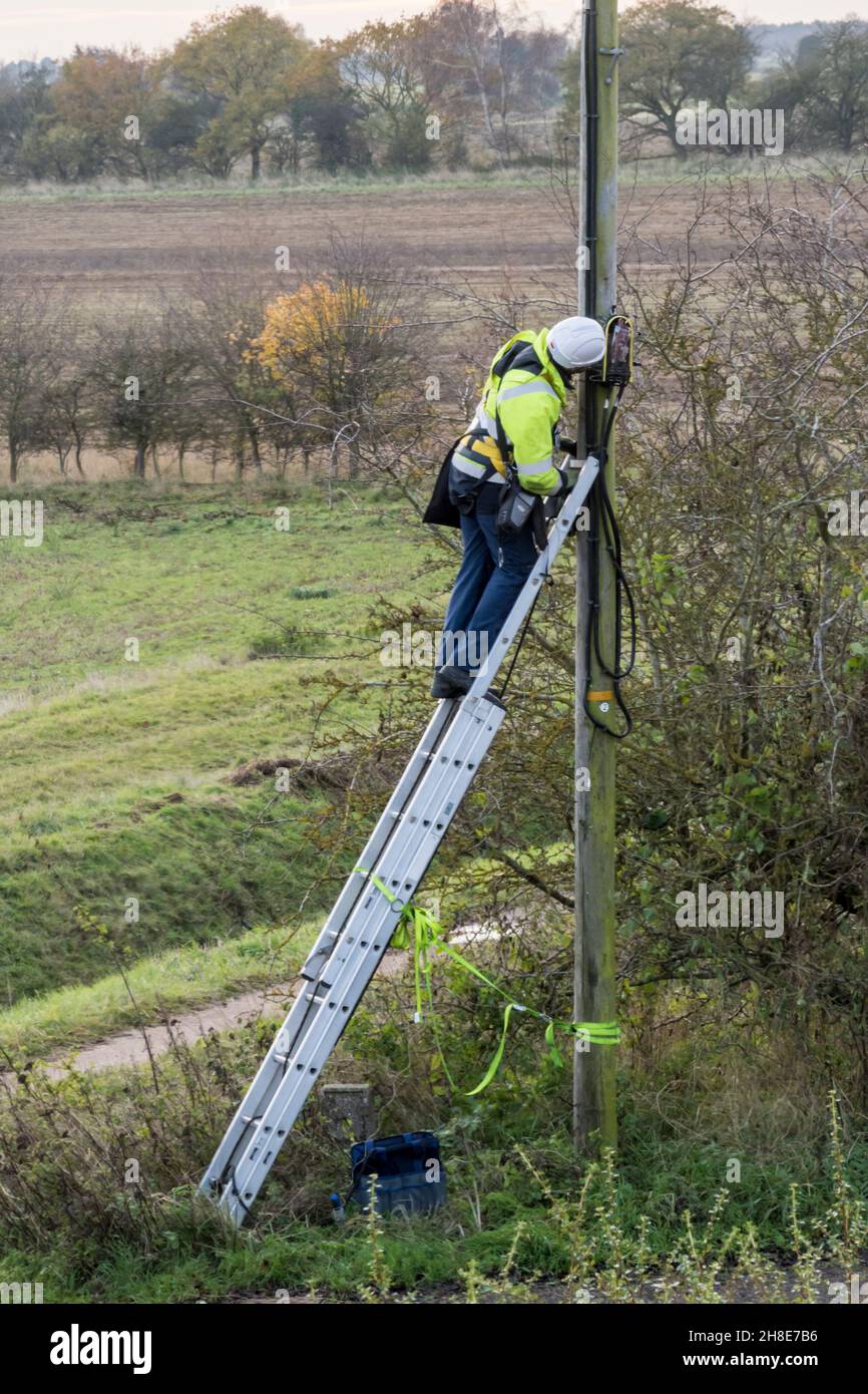 BT Openreach engineer working on a line in rural Norfolk countryside. Stock Photo