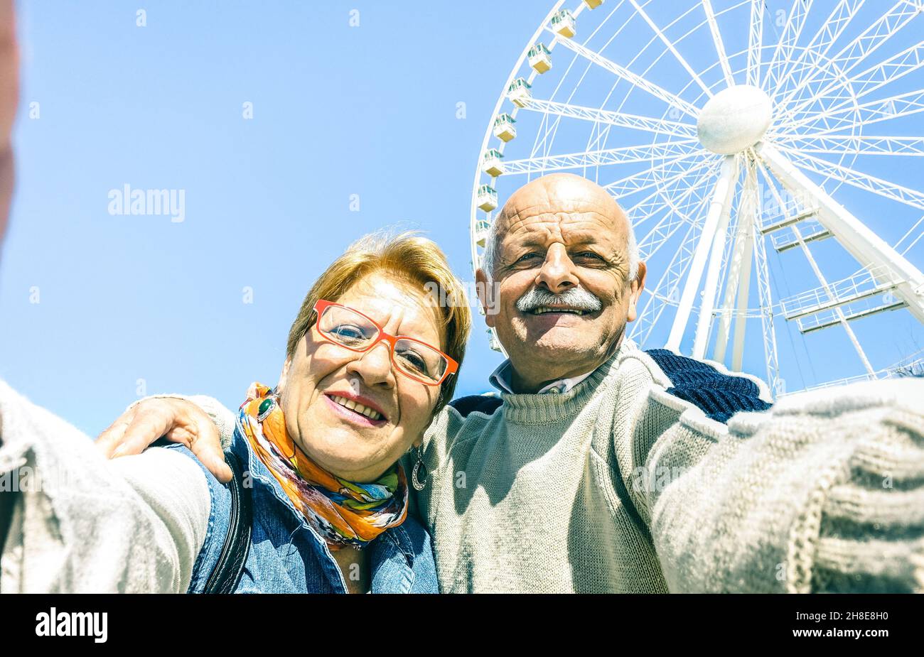 Happy retired senior couple taking selfie at winter travel around world - Active playful elderly concept having fun together - Mature people Stock Photo