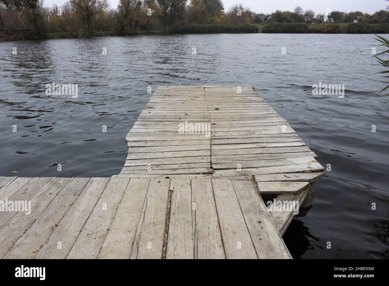 Fishing spot. Empty wooden deck floor over the lake Stock Photo