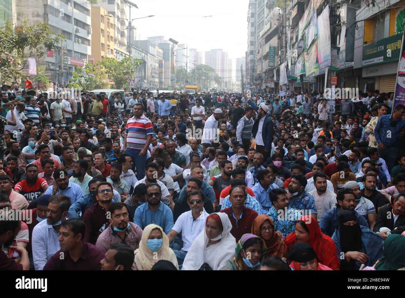 Activists of the Bangladesh Nationalist Party (BNP) sit on road during Bangladesh Nationalist Party’s protest rally demanding the government to allow party's chairperson Begum Khaleda Zia to be allowed international travel for better health treatment in Dhaka, Bangladesh. Stock Photo