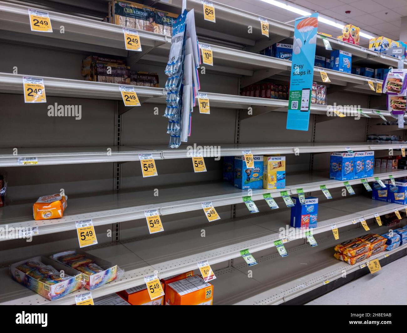 Kirkland, WA USA - circa October 2021: Angled view of low inventory in the snack aisle at SAfeway grocery store, during a back-to-school snack shortag Stock Photo