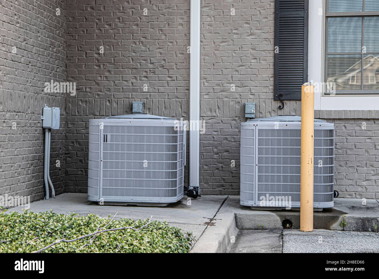 Row of outdoor residential air conditioning units in rural