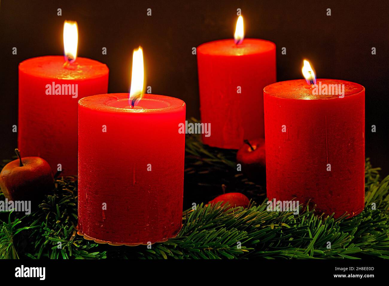 advent wreath with four burning candles for the fourth advent sunday