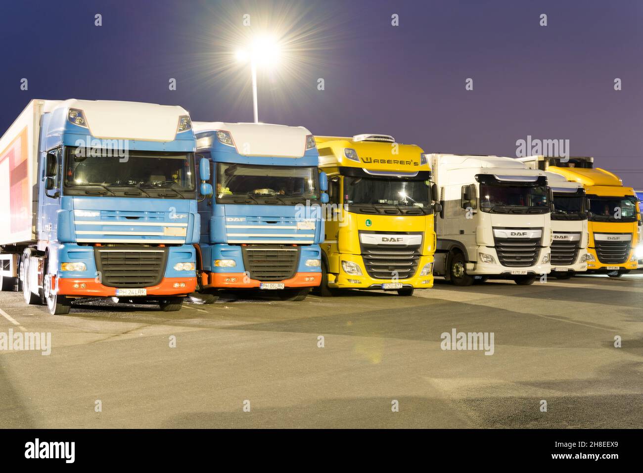 Rows of long distance haulage HGV truck park over night when drivers rest for the night England UK Stock Photo