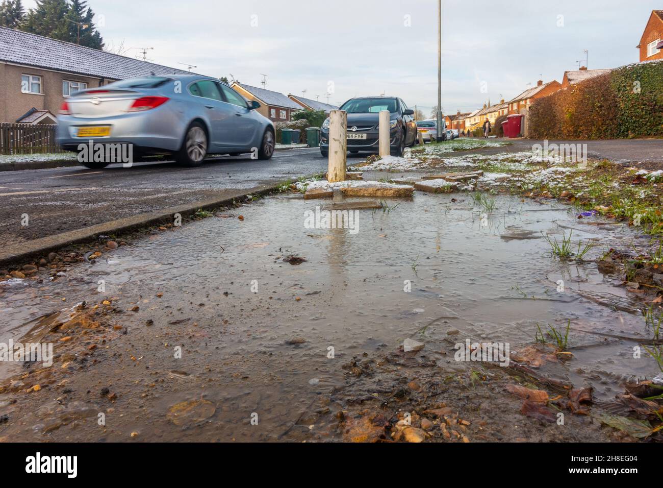 A frozen muddy puddle at the side of a road in Reading, UK. Stock Photo