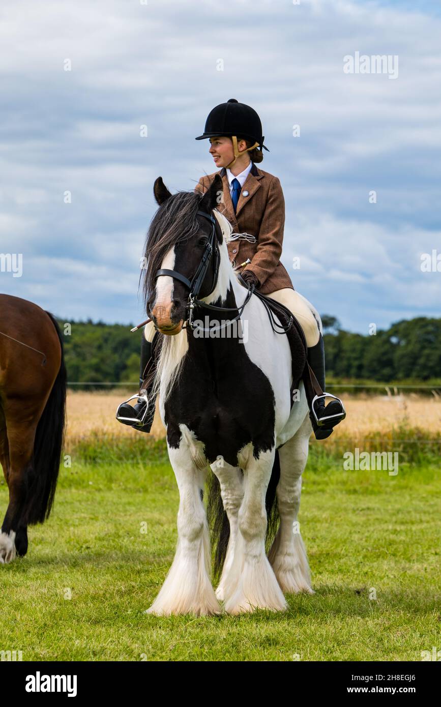 Girl riding horse at outdoor Summer horse event, East Lothian, Scotland, UK Stock Photo