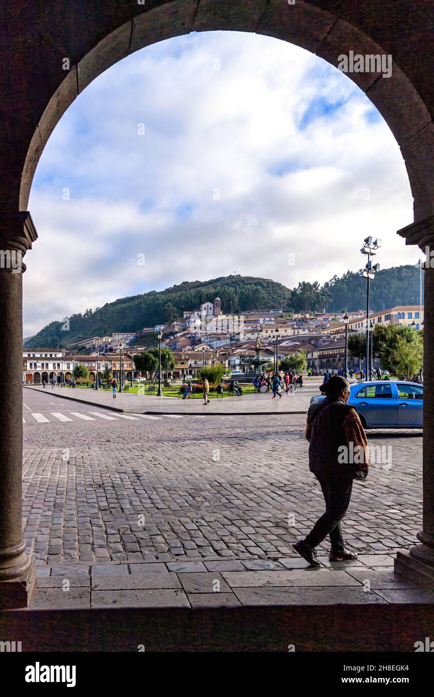 Looking across the Plaza De Armas in Cusco towards the Mirador of San Cristobal and the cross on the hillside above the city Stock Photo