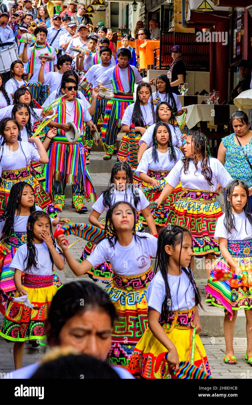 Young Peruvians dancing in the main street through Aguas Calientes during the Festival of the Crosses procession Stock Photo