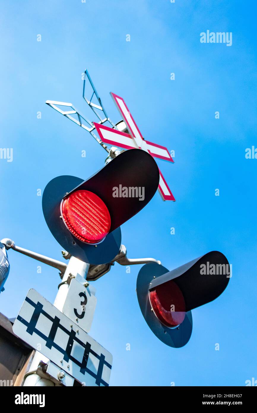 flashing red warning lights on American railroad crossing Stock Photo