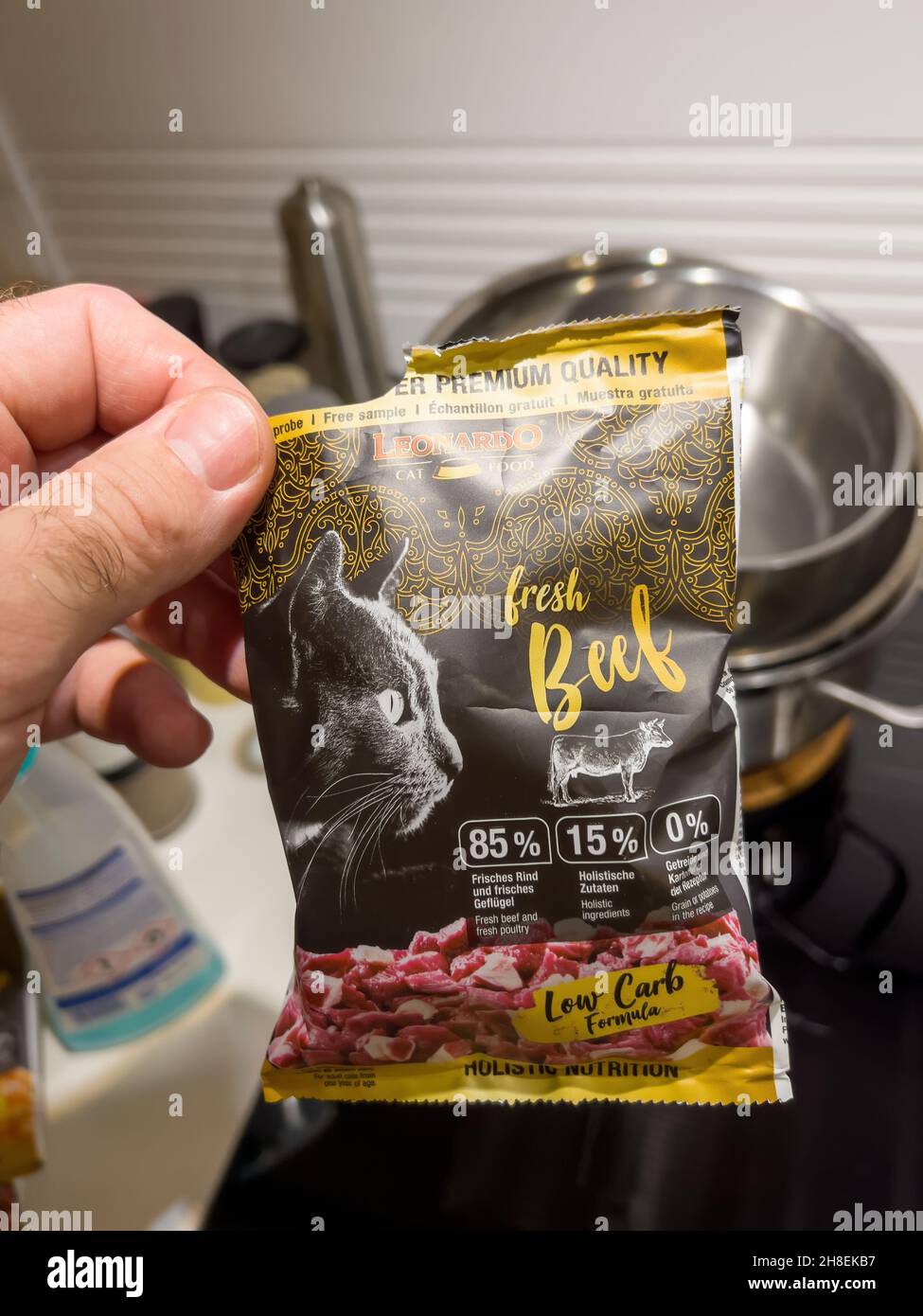 Male hand holding sample cat food manufactured by Leonardo Stock Photo Alamy