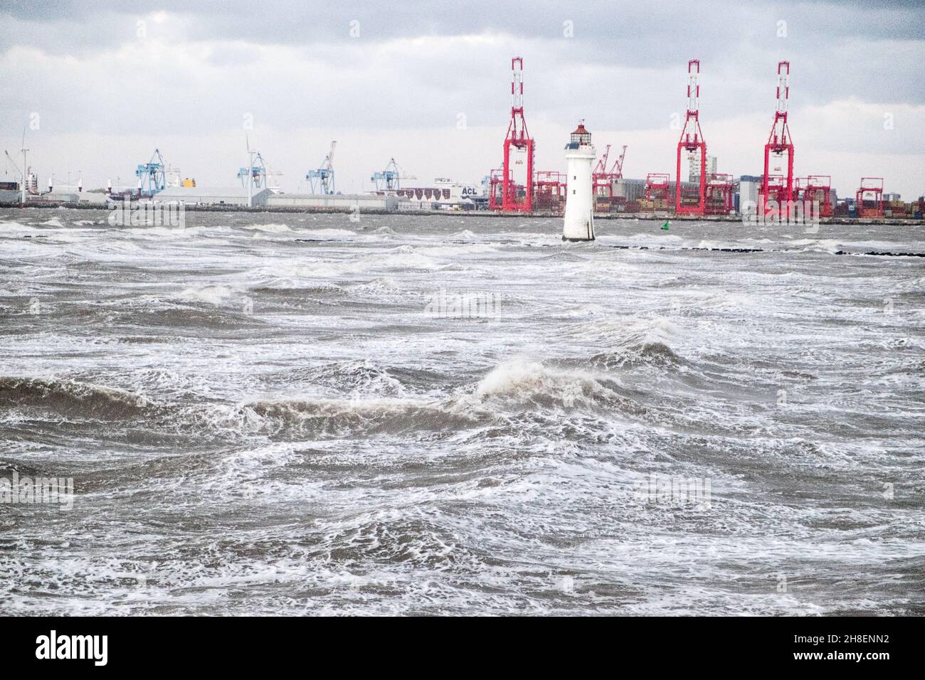 Liverpool, UK. 26th Nov, 2021. Photo taken from New Brighton of gale force winds blowing with rough seas.Lighthouse at New Brighton and Liverpool waterfront in background. Stock Photo
