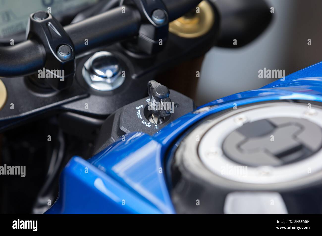 Closeup of the handlebars and the key of a modern motorcycle outdoors