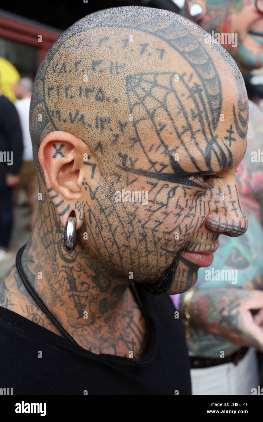 Portrait of  man with his face full of tattoos . Stock Photo