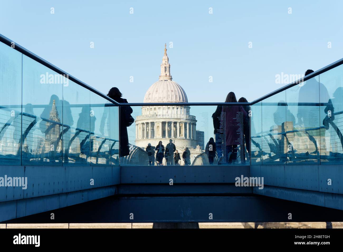 London, Greater London, England, November 23 2021:  People walking along Millennium Bridge with St Pauls cathedral behind. Stock Photo