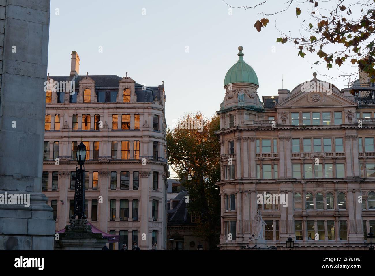 London, Greater London, England, November 23 2021: Golden evening autumn light is reflected in windows on buildings near St Pauls Cathedral. Stock Photo