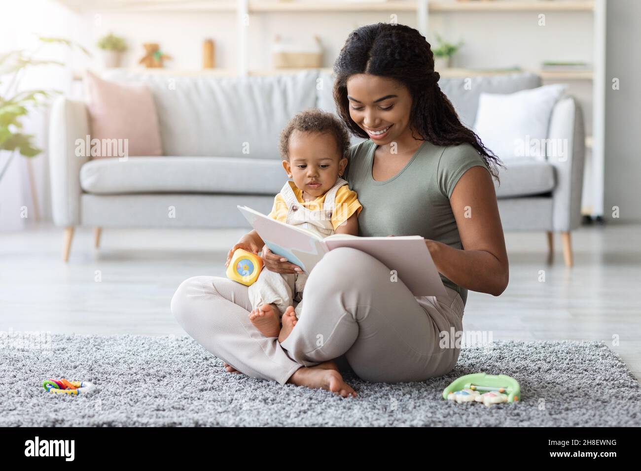 Mother Baby Leisure. Black Mom Reading Book To Toddler Son At Home ...