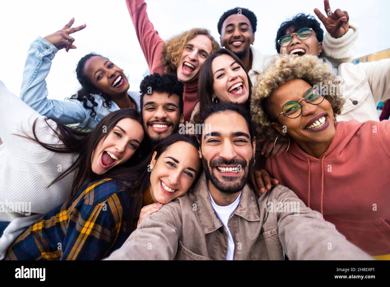 Big group portrait of diverse young people together outdoors Stock Photo