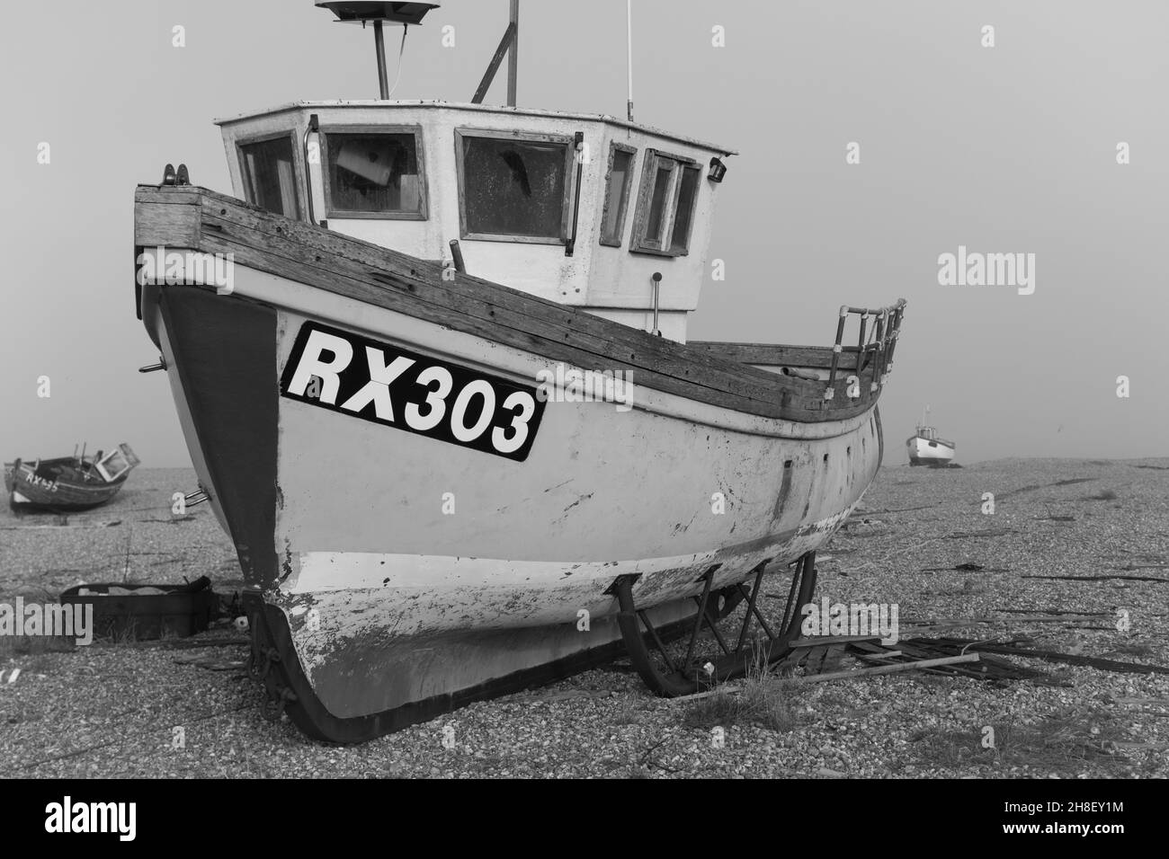 Black and white wooden fishing boat on english beach Stock Photo - Alamy
