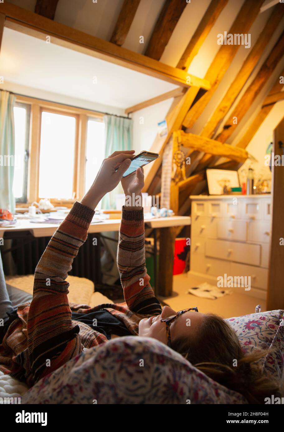 Woman using smart phone at home Stock Photo