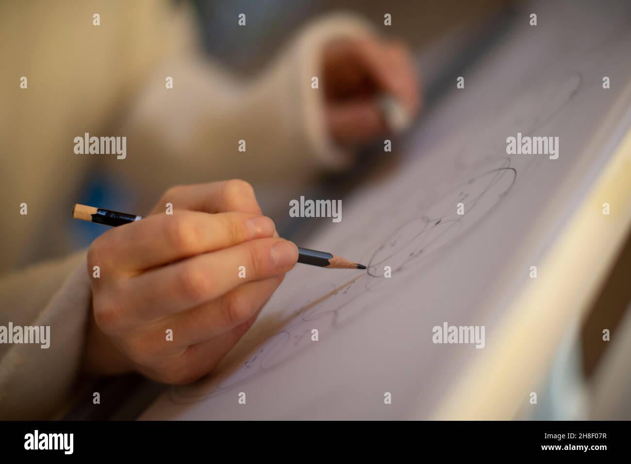Close up female architect with pencil drafting blueprint Stock Photo