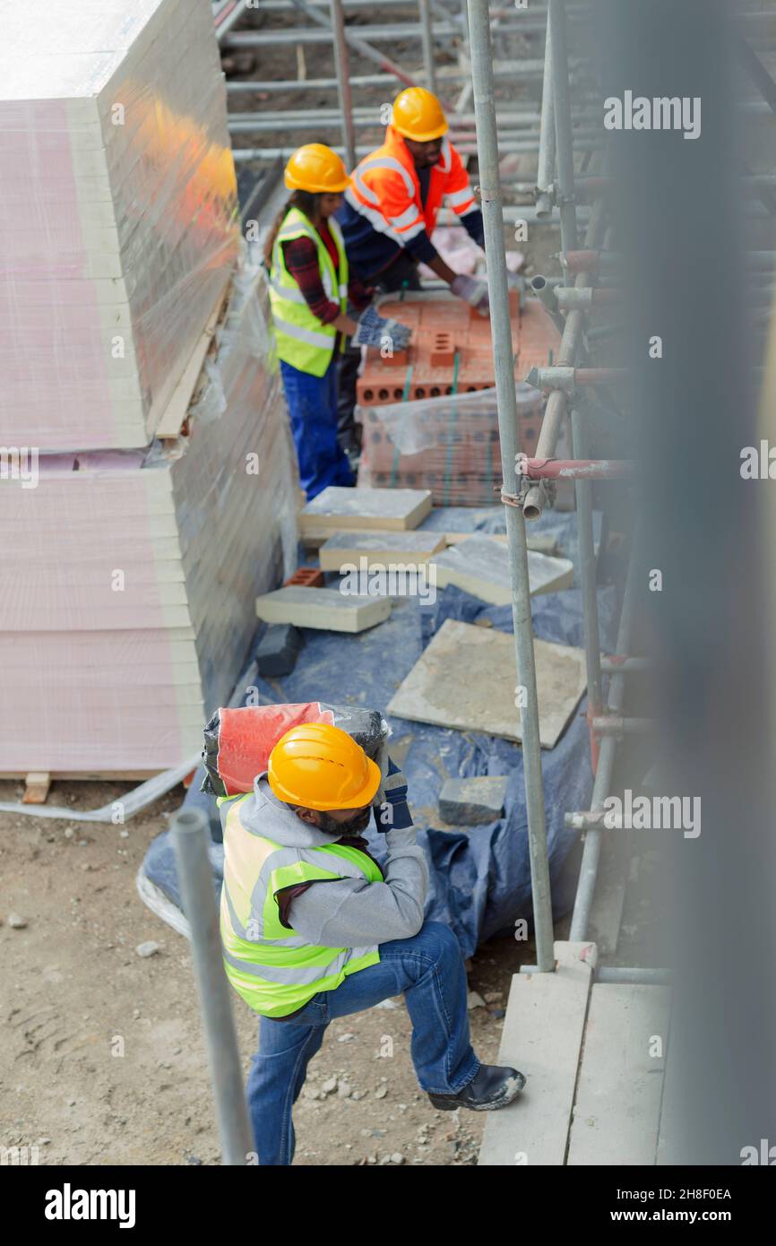 Construction workers at construction site Stock Photo - Alamy
