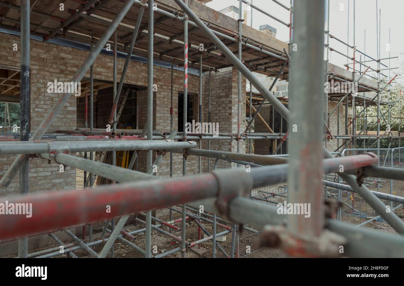 Scaffolding over brick building under construction Stock Photo