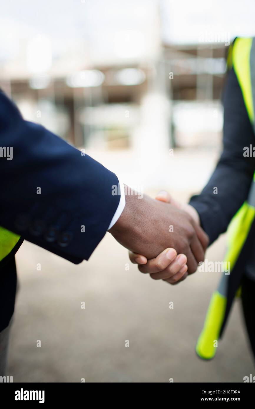 Close up engineers shaking hands Stock Photo