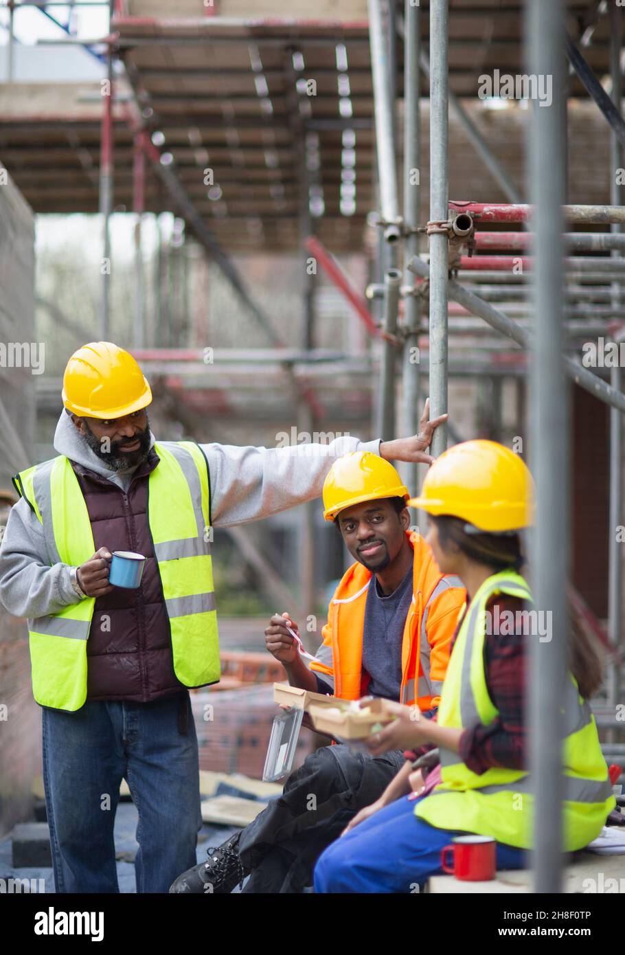 Construction workers enjoying lunch break at construction site Stock Photo