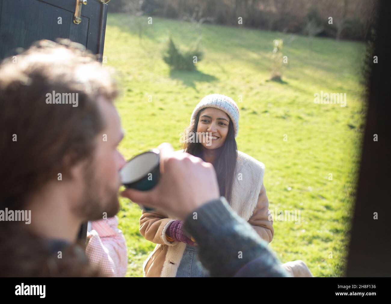 Young couple enjoying coffee at campsite Stock Photo