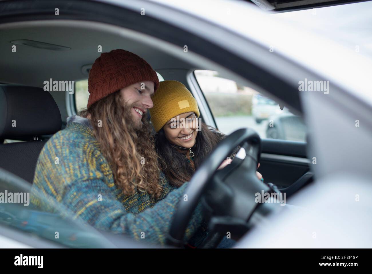 Smiling young couple inside car Stock Photo