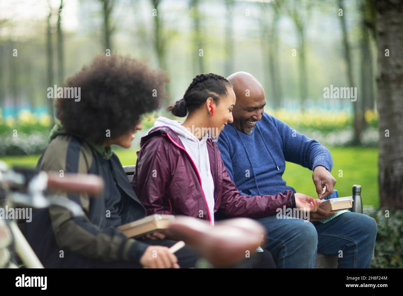 Happy family enjoying lunch in park Stock Photo