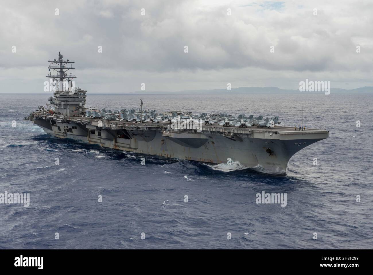 The U.S. Navy Nimitz-class nuclear-powered aircraft carrier USS Ronald Reagan departs Guam on a routine patrol as the flagship of the 5th Fleet September 29, 2016 in the Philippine Sea. Stock Photo