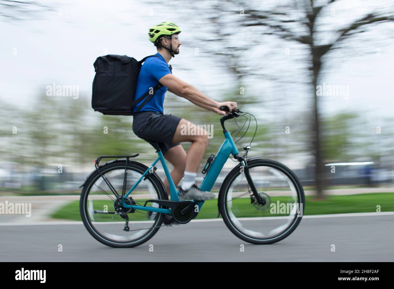 Courier Riding Courier bag on bicycle hi-res stock photography and images - Alamy