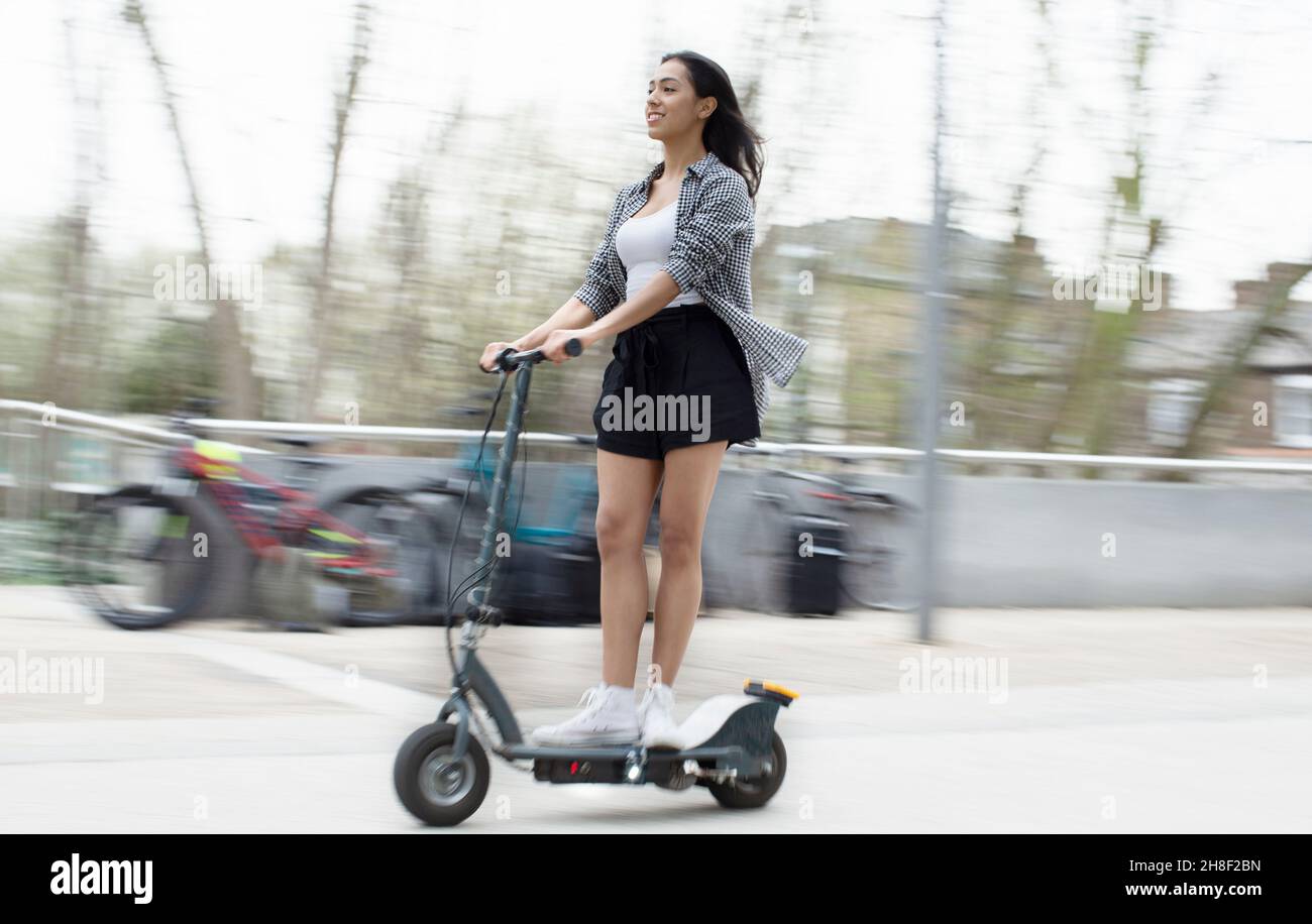 Woman on an electric scooter hi-res stock photography and images - Alamy