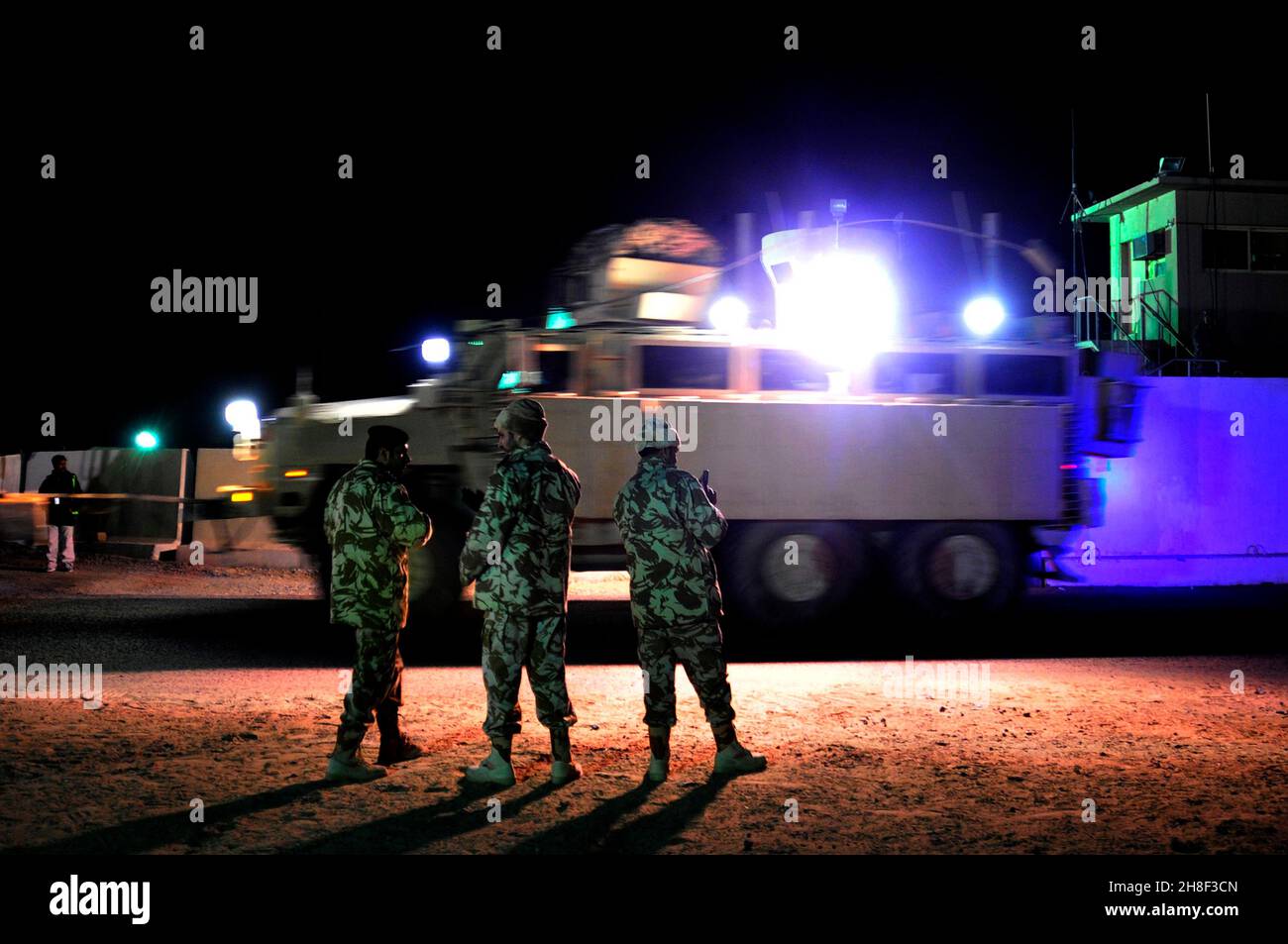 MRAP armored vehicles with the 4th Stryker Brigade, 2nd Infantry Division, carry the last remaining U.S. military forces as they drive across the Iraqi border from Iraq to Kuwait December 18, 2011 at K-Crossing, Kuwait. Stock Photo