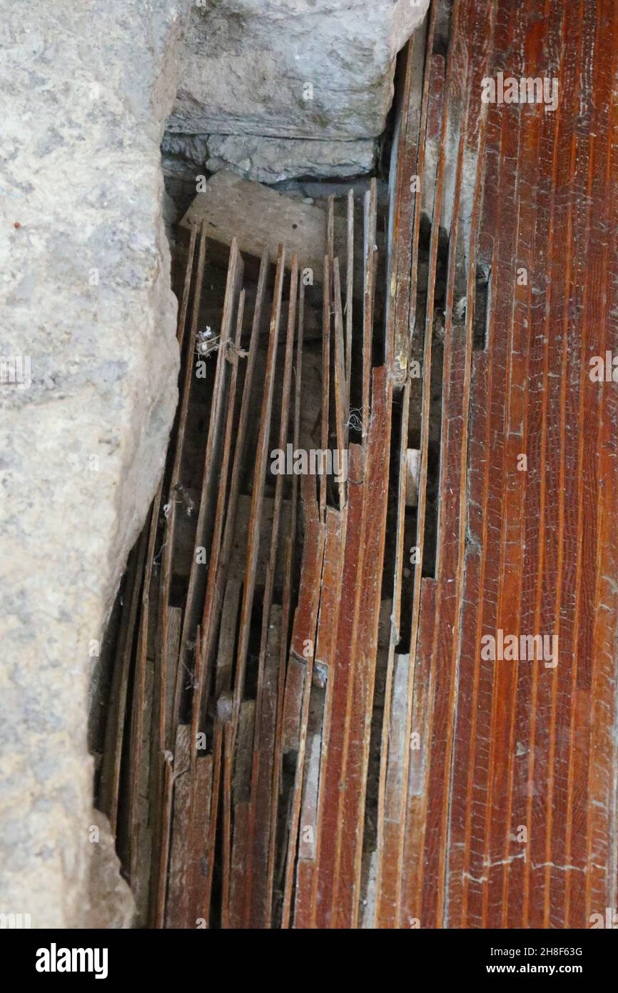 Plywood was a new material and here FLW cut strips and stood them on end as a flooring material. This is a picture of damage and delamination, likely Stock Photo
