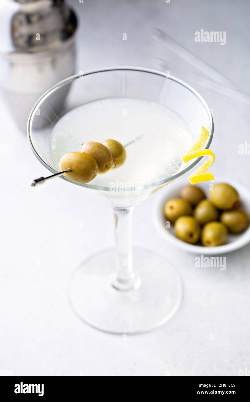 Classic lemon drop martini with olives and a lemon twist Stock Photo