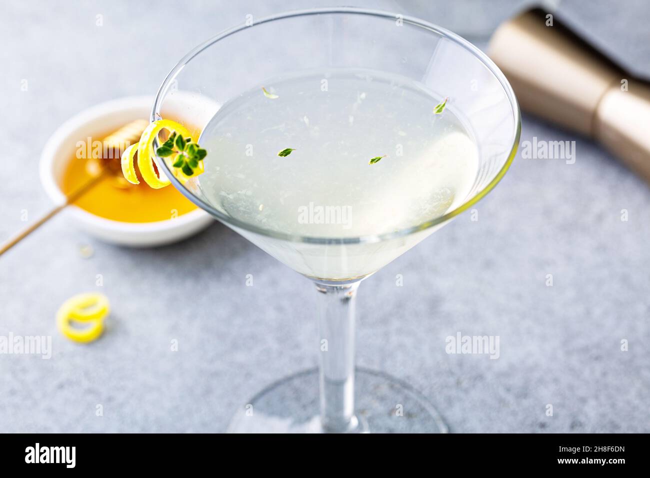 Honey and thyme lemon drop martini with garnish Stock Photo Alamy