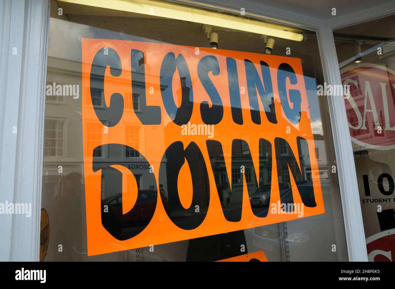 Closing down sign in shop window. Stock Photo