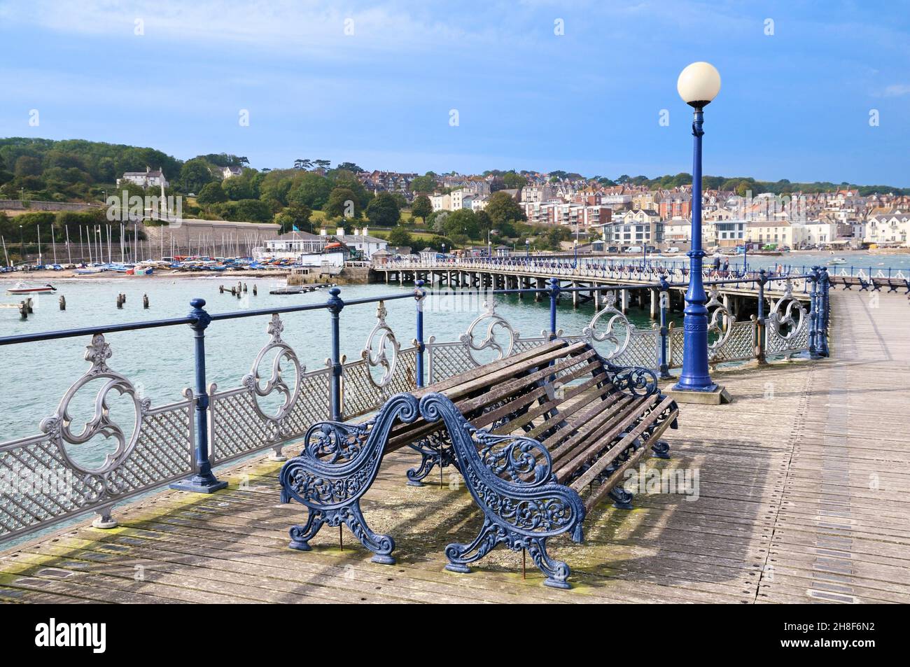 On the boardwalk of the restored Swanage Pier with its ornate benches, railings and lamp posts, Isle of Purbeck, Jurassic Coast, Dorset, England, UK Stock Photo